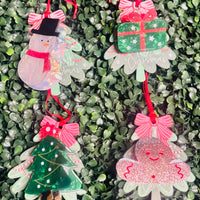 Festive acrylic Christmas claw clips in tree, gingerbread man, present, and snowman designs. Perfect for holiday hairstyles!