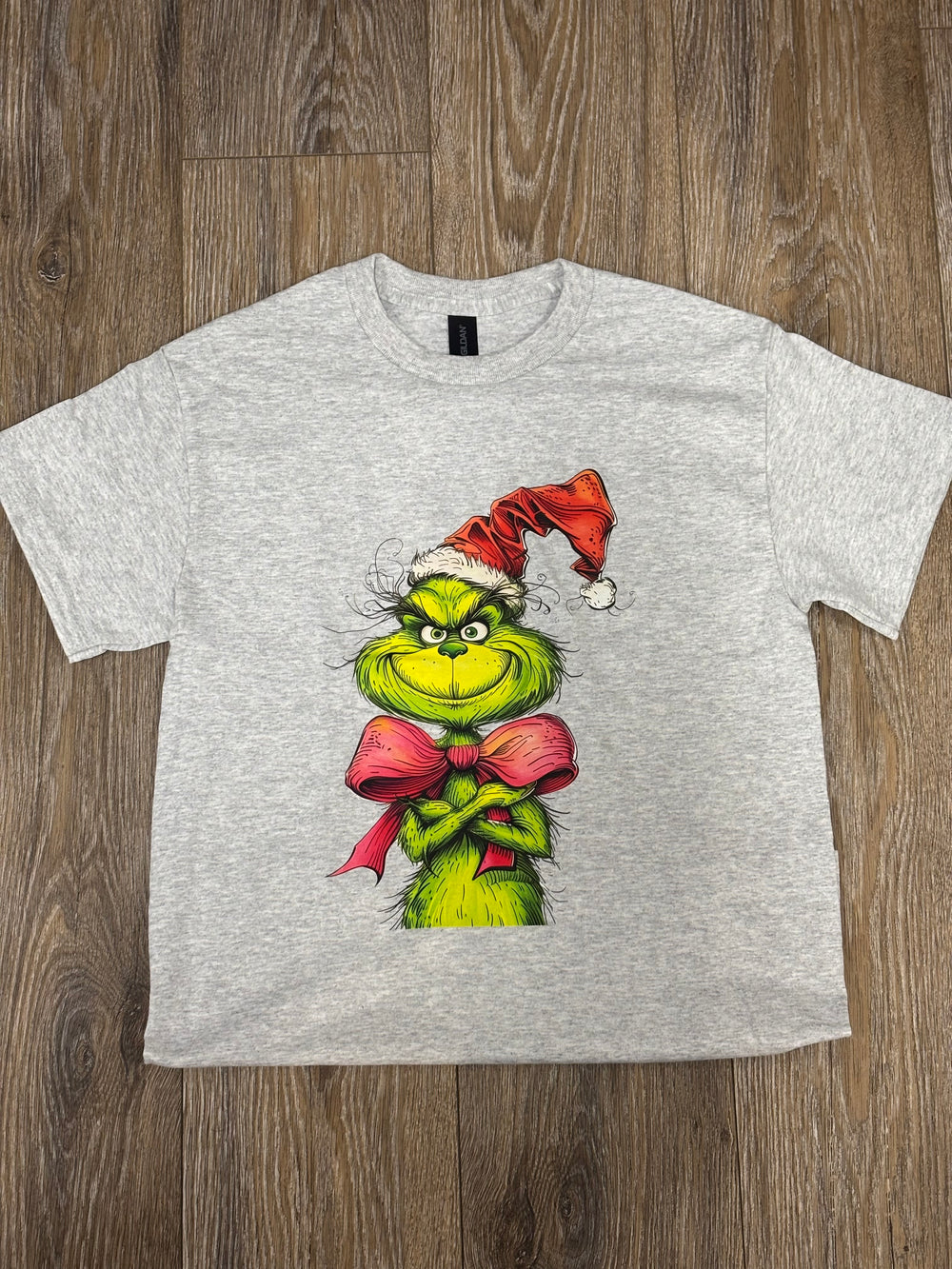 Christmas Grinch t-shirt

Grinch Santa hat tee

Holiday graphic tee

Unisex Christmas shirt

Gildan polyblend tee

Festive Grinch bow tie design

Screenprint Christmas shirt

Holiday short sleeve tee

Fun Christmas apparel

Cozy seasonal t-shirt