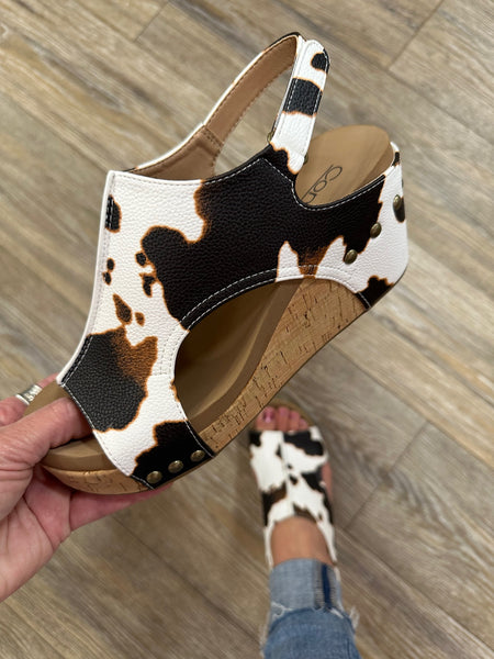 Step up your style with Corky's Carley Wedge in Smooth Cow. Featuring a sleek, classy design and signature Marshmallow soles for all-day comfort.