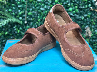 a sporty silhouette with a velcro mary jane strap, squishy footbed, and rich chestnut suede detailing