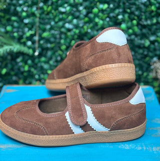 a sporty silhouette with a velcro mary jane strap, squishy footbed, and rich chestnut suede detailing