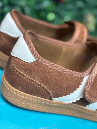 a sporty silhouette with a velcro mary jane strap, squishy footbed, and rich chestnut suede detailing