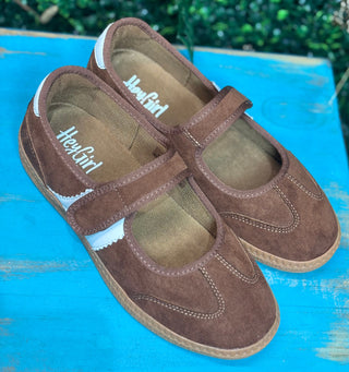 a sporty silhouette with a velcro mary jane strap, squishy footbed, and rich chestnut suede detailing