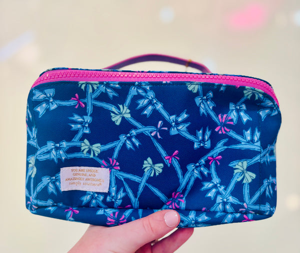 Blue pouch with bow pattern and pink zipper & handle