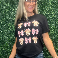 Elevate your everyday style with the Cow Coquette Bow Tee—a playful mix of chic and cozy. Featuring a charming cow print accented with a sweet coquette-inspired bow, this tee blends comfort with personality, letting you showcase your unique charm on any occasion. ✨