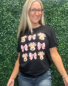 Elevate your everyday style with the Cow Coquette Bow Tee—a playful mix of chic and cozy. Featuring a charming cow print accented with a sweet coquette-inspired bow, this tee blends comfort with personality, letting you showcase your unique charm on any occasion. ✨
