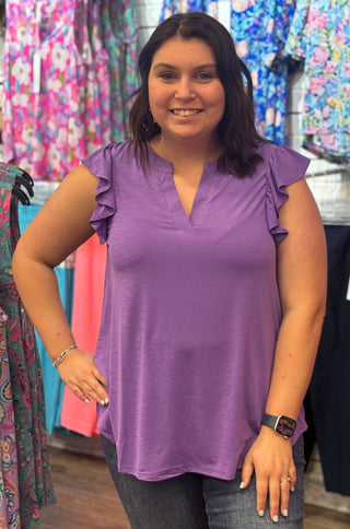 Feminine details, effortless wear. The Lizzy Flutter Top brings together a mandarin collar, pleated back detail, and soft flutter sleeves in a relaxed stretchy knit that moves with you — a wardrobe staple that works as hard as you do.
