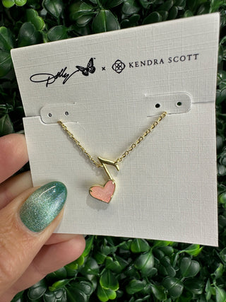 Featuring a radiant light pink drusy heart, this necklace shimmers beautifully as it catches the light, framed in a polished gold setting. The playful music note detail adds a signature Dolly-inspired touch, making this piece perfect for music lovers and fans of timeless Southern sparkle.