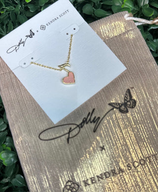 Featuring a radiant light pink drusy heart, this necklace shimmers beautifully as it catches the light, framed in a polished gold setting. The playful music note detail adds a signature Dolly-inspired touch, making this piece perfect for music lovers and fans of timeless Southern sparkle.