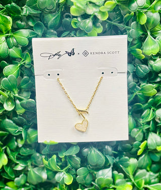 Dolly Parton x Kendra Scott Ari Heart Music Note Necklace in gold with iridescent drusy heart. A sparkling music-inspired pendant.