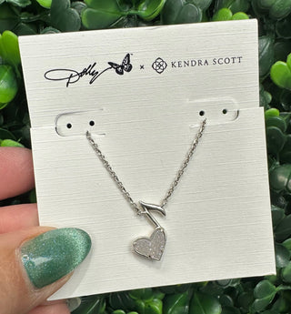 The pendant features a stunning iridescent drusy heart that shimmers with multidimensional sparkle, beautifully framed in a vintage silver finish. The music note accent pays tribute to Dolly’s legendary influence, making this necklace the perfect piece for music lovers and fans of timeless Southern charm.