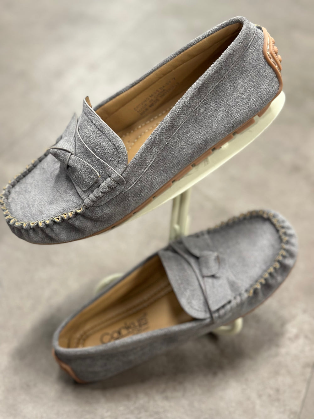 Corky's Driving Miss Daisy – Grey Faux Suede

Classic comfort meets timeless charm in the Corky's Driving Miss Daisy loafer. Crafted in a soft faux suede, this moccasin-style slip-on features hand-stitched detailing and a sweet bow accent for a polished finish. The cushioned insole and flexible rubber sole make it perfect for long days on your feet—whether you're running errands or enjoying a weekend drive.