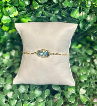 Elaina Luxe Chain Bracelet gold light blue with cubic zirconia oval stone on silver paperclip chain.