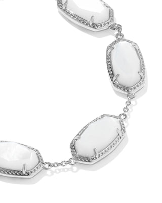 Brand | Kendra Scott
Style | Link Bracelet
Design | Series of signature oval-shaped stones linked together for a sculptural, eye-catching silhouette
Material | Ivory Mother of Pearl
Metal | Rhodium Over Brass
Closure | Lobster clasp with a single adjustable slider bead
Size | 6.5" L, 0.38" W with 1.5" extender