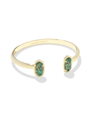 Style | Dainty pinch cuff with signature oval stone stations

Metal | 14k yellow gold over brass

Stone | Bronze-veined green malachite

Fit | Adjustable cuff

Size | 2.28-inch inner diameter; 0.67-inch L x 0.38-inch W station