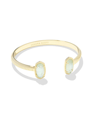 Style | Dainty pinch cuff with signature oval stone stations

Metal | 14k yellow gold over brass

Stone | Light blue illusion

Fit | Adjustable cuff

Size | 2.28-inch inner diameter; 0.67-inch L x 0.38-inch W station

Natural Var