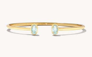 Stone | Light Blue Illusion
Finish | Gold tone
Design | Minimalist cuff bookended by Kendra Scott's Emilie micro icon
Inner Diameter | 2.83"
Station Size | 0.32" L x 0.2" W
Fit | Adjustable cuff