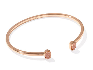 Stone | Sand Drusy
Finish | Rose gold tone
Design | Minimalist cuff bookended by Kendra Scott's Emilie micro icon
Inner Diameter | 2.83"
Station Size | 0.32" L x 0.2" W
Fit | Adjustable cuff