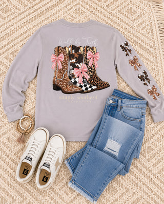 Simply Southern Long Sleeve Tee 
Features the saying "walk by faith" with three pairs of cowgirl boots on the back of the tee with pink bows. 
Printed on a grey/brown (driftwood) color tee