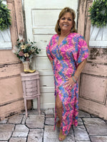 This stunning maxi dress features flutter sleeves, a side slit, and a burst of color. True-to-size and perfect for any occasion, it's sure to turn heads!
