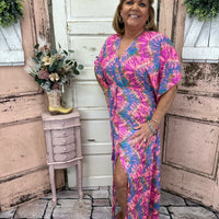 This stunning maxi dress features flutter sleeves, a side slit, and a burst of color. True-to-size and perfect for any occasion, it's sure to turn heads!