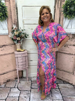 This stunning maxi dress features flutter sleeves, a side slit, and a burst of color. True-to-size and perfect for any occasion, it's sure to turn heads!
