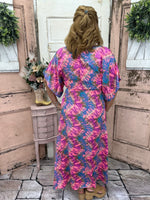 This stunning maxi dress features flutter sleeves, a side slit, and a burst of color. True-to-size and perfect for any occasion, it's sure to turn heads!
