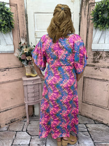 This stunning maxi dress features flutter sleeves, a side slit, and a burst of color. True-to-size and perfect for any occasion, it's sure to turn heads!