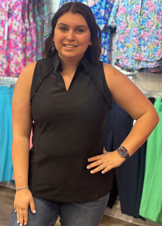 Classic polo structure, reimagined for warm weather. The Genesis Sleeveless Polo in Black pairs a polished collar V-neck with delicate ruffle detail at the underarms — a feminine touch that sets it apart from the standard. Cooling UPF50+ fabric keeps you protected and comfortable, while the lightweight, wrinkle-resistant construction makes it a reliable go-to from the golf course to the patio.
