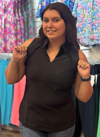 Classic polo structure, reimagined for warm weather. The Genesis Sleeveless Polo in Black pairs a polished collar V-neck with delicate ruffle detail at the underarms — a feminine touch that sets it apart from the standard. Cooling UPF50+ fabric keeps you protected and comfortable, while the lightweight, wrinkle-resistant construction makes it a reliable go-to from the golf course to the patio.