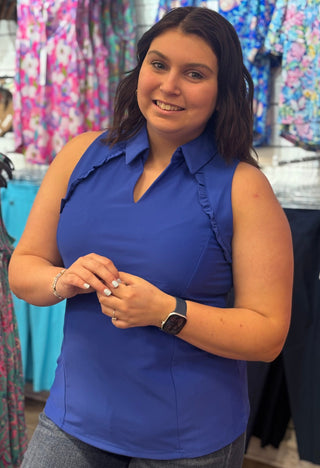 Classic polo structure, reimagined for warm weather. The Genesis Sleeveless Polo in Royal Blue pairs a polished collar V-neck with delicate ruffle detail at the underarms — a feminine touch that sets it apart from the standard. Cooling UPF50+ fabric keeps you protected and comfortable, while the lightweight, wrinkle-resistant construction makes it a reliable go-to from the golf course to the patio.
