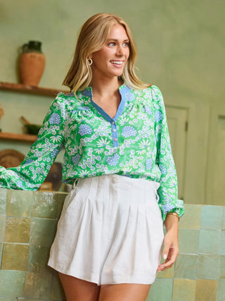 The Gianna Top adds personality to an everyday essential. Designed with a button-front placket, long sleeves with elastic cuffs, and a ruffle neckline, it’s easy to wear and full of charm. Pair it with your favorite denim for laid-back days or style it with tailored pieces for a dressed-up look that still feels effortless.