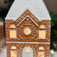 Festive Gingerbread House Fragrance Warmer with top-down wax warming and cozy canopy glow. Includes bulb. Flame-free, safe, and perfect for holiday décor.