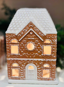 Festive Gingerbread House Fragrance Warmer with top-down wax warming and cozy canopy glow. Includes bulb. Flame-free, safe, and perfect for holiday décor.
