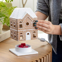 Festive Gingerbread House Fragrance Warmer with top-down wax warming and cozy canopy glow. Includes bulb. Flame-free, safe, and perfect for holiday décor.
