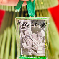Acrylic glitter-filled photo ornament fits a wallet-size picture. A festive way to display cherished memories on your Christmas tree.