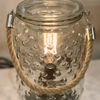 Add a touch of timeless elegance to your space with the Art Glass Lamp Vintage Illumination Warmer. Inspired by midcentury design, this all-glass warmer features a white and clear art glass pattern that softly glows with warm orange tones when lit. The vintage-style bulb and matching glass wax tray create a beautiful, flame-free way to fill your home with your favorite fragrances.