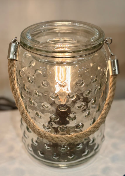 Add a touch of timeless elegance to your space with the Art Glass Lamp Vintage Illumination Warmer. Inspired by midcentury design, this all-glass warmer features a white and clear art glass pattern that softly glows with warm orange tones when lit. The vintage-style bulb and matching glass wax tray create a beautiful, flame-free way to fill your home with your favorite fragrances.