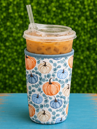 Fit | Designed for medium iced cups: Dunkin' Medium, Starbucks Venti, McCafé Large, and other 22–28oz cold beverage cups
Material | 4mm thick neoprene — flexible, lightweight, and durable
Insulation | Keeps drinks cold 2+ hours; stops condensation
Grip | Easy-grip hand strap for comfortable carrying
Drip Protection | Stops messy drips and keeps hands dry and warm
Storage | Folds flat for easy on-the-go use
Print | Pumpkin Grove — illustrated pumpkins, vines, and fall foliage in warm harvest tones