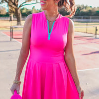 Elevate your game with the Pep Squad Tennis Dress in pink. Featuring a colorful contrasting front zipper, this dress combines style and sport to keep you comfortable and fashionable on the court. Stay on top of your game with this must-have piece.

