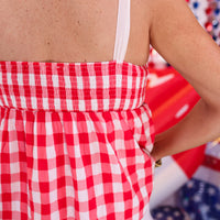 Add sweetness to your style with our Sweet As Apple Pie Top! This plaid, patriotic babydoll top has tie straps & a smocked back—perfect for summer fun!