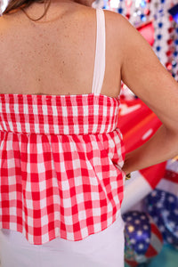 Add sweetness to your style with our Sweet As Apple Pie Top! This plaid, patriotic babydoll top has tie straps & a smocked back—perfect for summer fun!