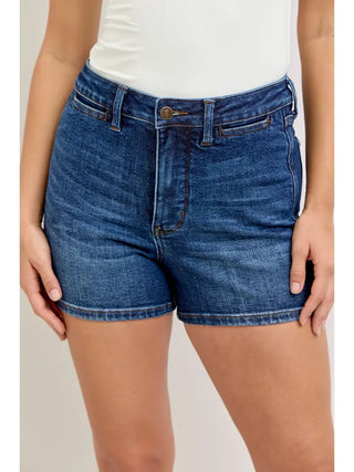 Flattering, comfortable, and made for your best warm-weather days. The Judy Blue High-Rise Tummy Control Shorts in medium wash combine a classic, versatile medium wash denim finish with a high waist, slim fit, and built-in tummy control for a polished, confidence-boosting silhouette that works effortlessly from everyday errands to summer celebrations. Crafted from a 94% Cotton / 5% Polyester / 1% Spandex blend, they offer just enough stretch for all-day comfort without sacrificing structure or shape.