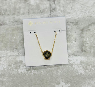 Embrace coastal vibes with the Brynne Gold Shell Pendant Necklace in Golden Obsidian. Its textured details and chic shell design shine solo or stacked.