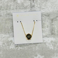 Embrace coastal vibes with the Brynne Gold Shell Pendant Necklace in Golden Obsidian. Its textured details and chic shell design shine solo or stacked.
