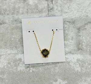 Embrace coastal vibes with the Brynne Gold Shell Pendant Necklace in Golden Obsidian. Its textured details and chic shell design shine solo or stacked.