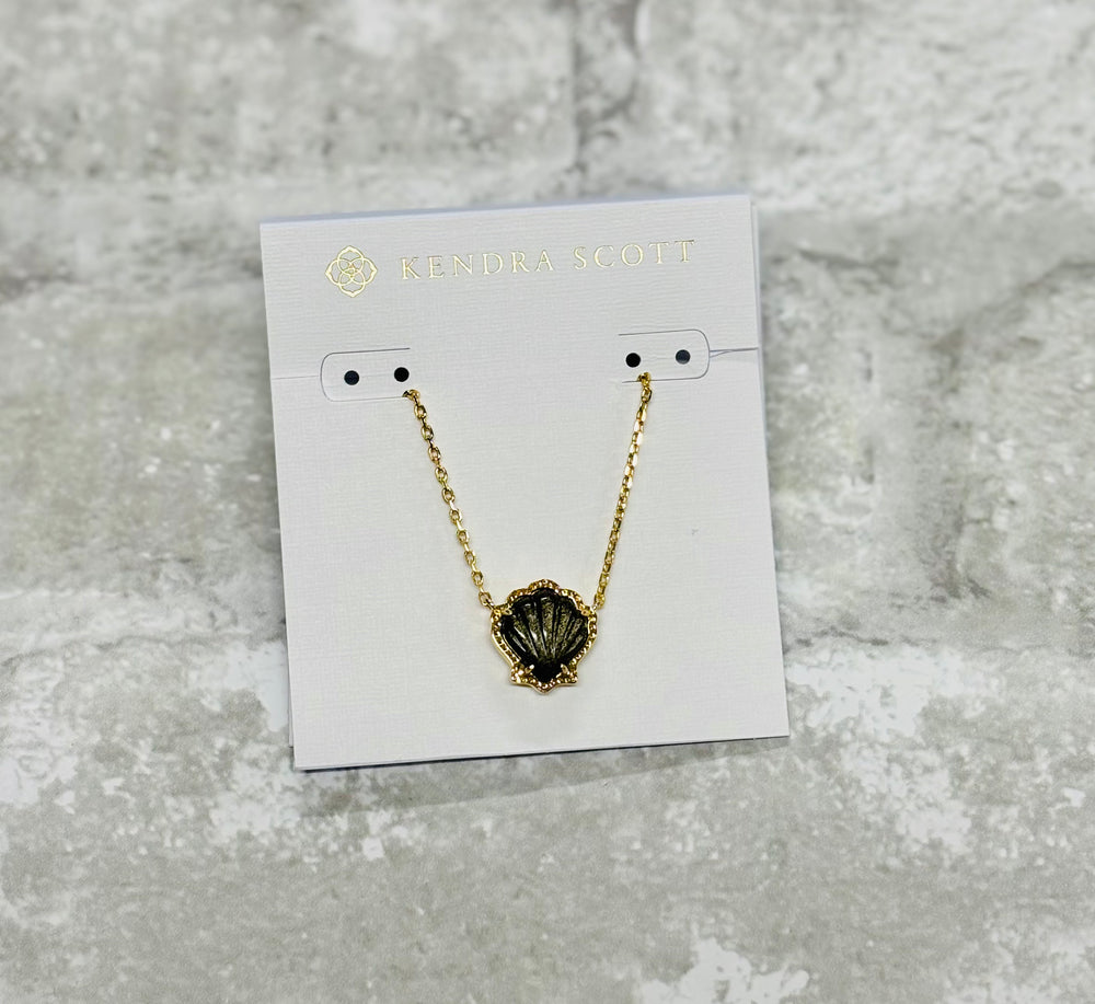 Embrace coastal vibes with the Brynne Gold Shell Pendant Necklace in Golden Obsidian. Its textured details and chic shell design shine solo or stacked.