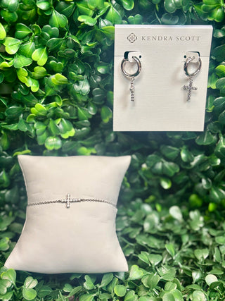 Silver cross crystal huggie hoop earrings with white crystal cross charm.
Silver delicate chain bracelet with white crystal cross charm.