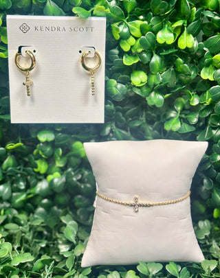 Kendra Scott gold delicate chain bracelet with white crystal cross charm.
Gold cross crystal huggie hoop earrings with white crystal cross charm.