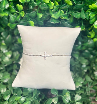 Silver delicate chain bracelet with white crystal cross charm.